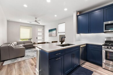 Kitchen with a sink, blue cabinets, and stainless