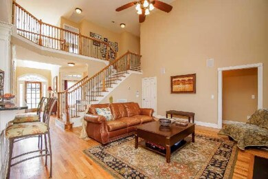 Beautiful sand & finish hardwood floors & gorgeous wrought iron staircase.