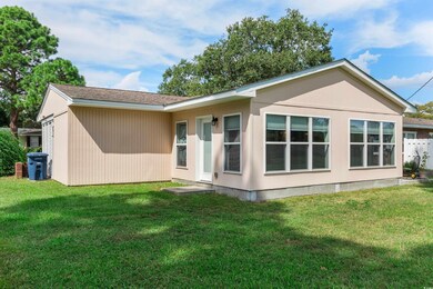 Rear view of house with a yard