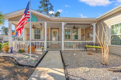 View of front of home with ceiling fan and covered