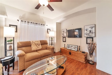 Living room with ceiling fan and wood finished floors