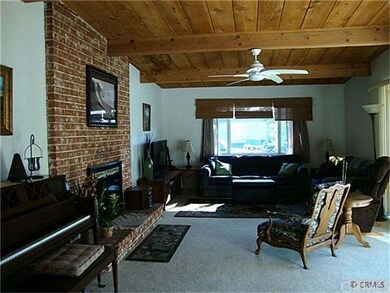 Living Room with ceiling fan and fireplace