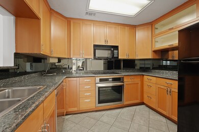 This kitchen has granite counters, plenty of stora