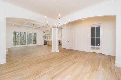 Unfurnished living room featuring ceiling fan with