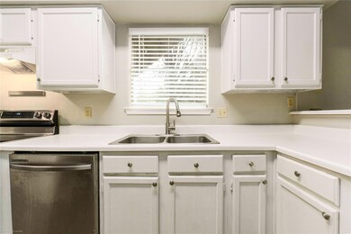Kitchen with stainless steel dishwasher, a sink, 