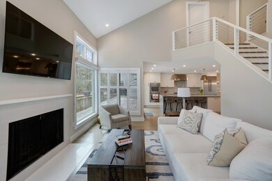 Light-filled living area with wood fireplace.