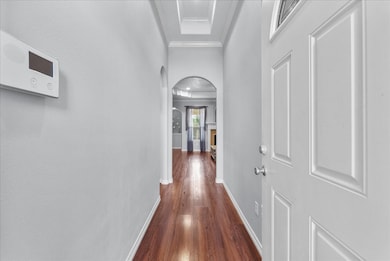 Step into an inviting entryway with warm floors and elegant tray ceilings that set the tone for the rest of the home.