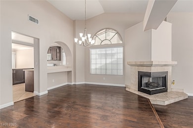 Unfurnished living room featuring lofted ceiling,