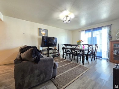 Living area featuring wood finished floors and a textured ceiling