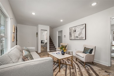 Living room with wood finished floors, baseboards,