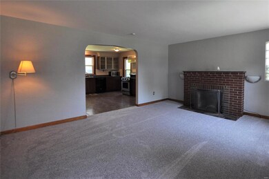 LIVING ROOM WITH ARCH AND FIREPLACE
