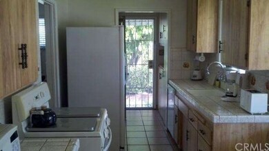 Kitchen with oven, dishwasher and laundry room.