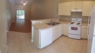KITCHEN LOOKING AT DINNING ROOM/LIVING ROOM AREA.