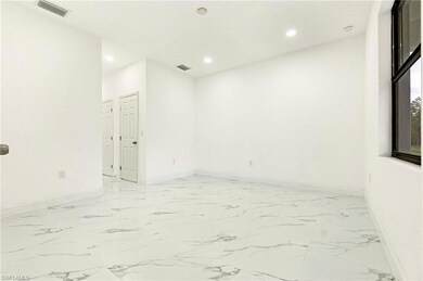 Unfurnished room with recessed lighting and light marble finish floors