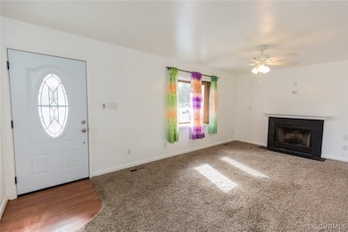 Living room with new flooring, bay style window, remote controlled fans and a wood burning fire place with blower.