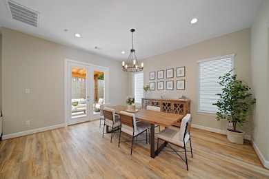 The dining area features high ceilings, recessed l