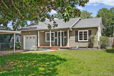 Single story home featuring a porch, roof with shi