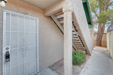 Property entrance featuring stucco siding