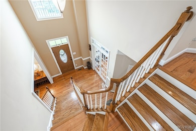 Entrance foyer with a high ceiling, stairway, ligh