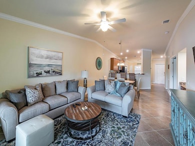 Tiled living room with vaulted ceiling, ceiling fa