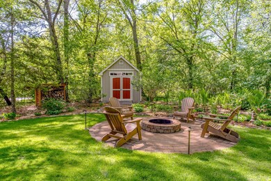 Immaculately kept grounds surround the home, with an open yard and firepit space designed for both entertaining and relaxation.