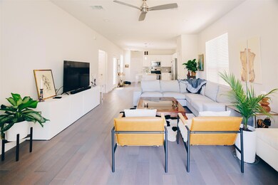 Living room featuring a ceiling fan, visible vent