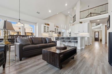 Living room featuring a high ceiling and light woo
