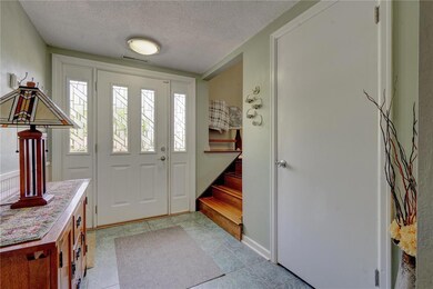 foyer - garage entry, laundry & basement stairs on