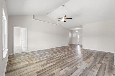 Unfurnished living room with high vaulted ceiling,