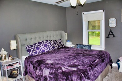 Master bedroom has wall to wall carpet, ceiling fa