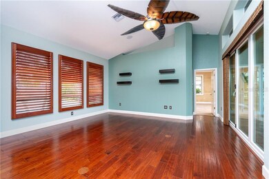 Living room with new doors to lanai, built-in shel