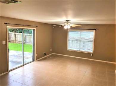 Unfurnished room with a ceiling fan and light tile patterned floors