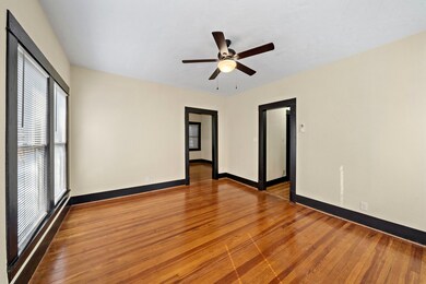 Stepping back into the Living Room. Doorway on left is Kitchen/Dining. Doorway on right is to Bedroom! Note original WOOD FLOORS throughout the house!