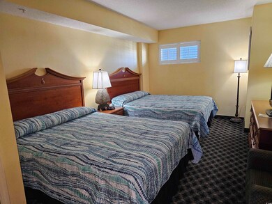 Bedroom featuring carpet and a textured ceiling