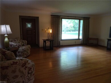 Spacious living room has picture window facing eas
