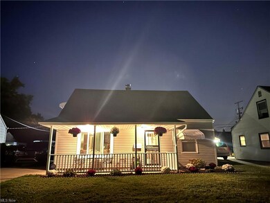 View of front of property with a lawn and a porch