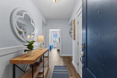 A bright, inviting foyer leads the way inside, featuring shiplap walls, chic lighting, and a coastal-inspired design that instantly feels like home.