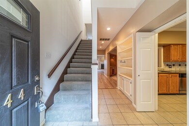 The stair is covered with carpet. The island kitch
