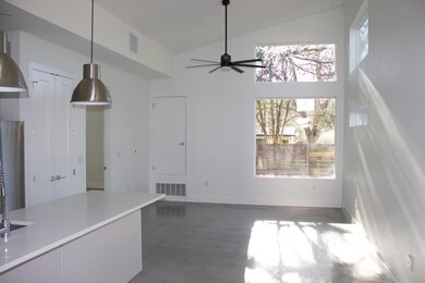 Unfurnished dining area with high vaulted ceiling