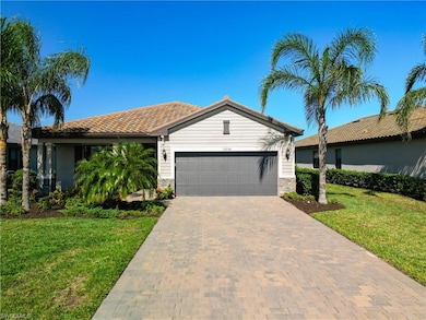 View of front facade with a garage and a front law