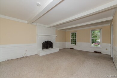 Family room with wood-burning fireplace.  Hardwood