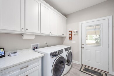 Laundry area featuring cabinet space, independent washer and dryer, and light wood-style floors