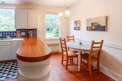 The eat in kitchen with hardwood floors.  Lots of storage under the bar and cabinets.