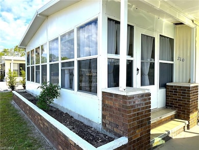 View of side of property featuring a sunroom