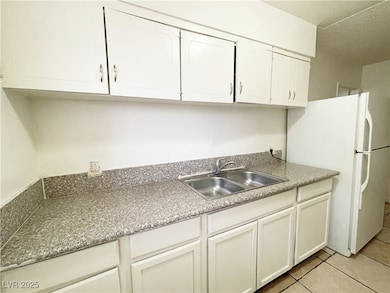 Kitchen featuring light tile patterned floors, whi