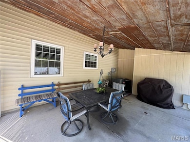 View of patio featuring outdoor dining area and area for grilling