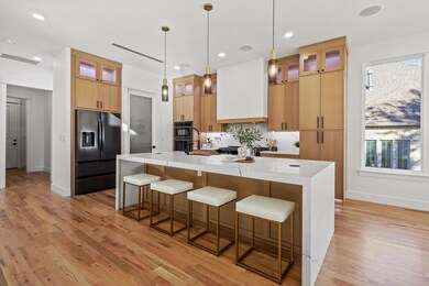 Kitchen with custom range hood, a spacious island,
