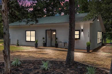 View of front of home featuring a porch and metal
