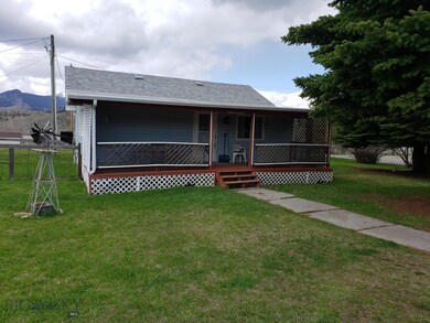 Back of main house with water well to the left