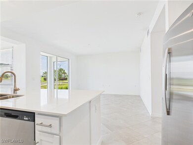 Kitchen with appliances with stainless steel finishes, white cabinets, light countertops, and light tile patterned flooring